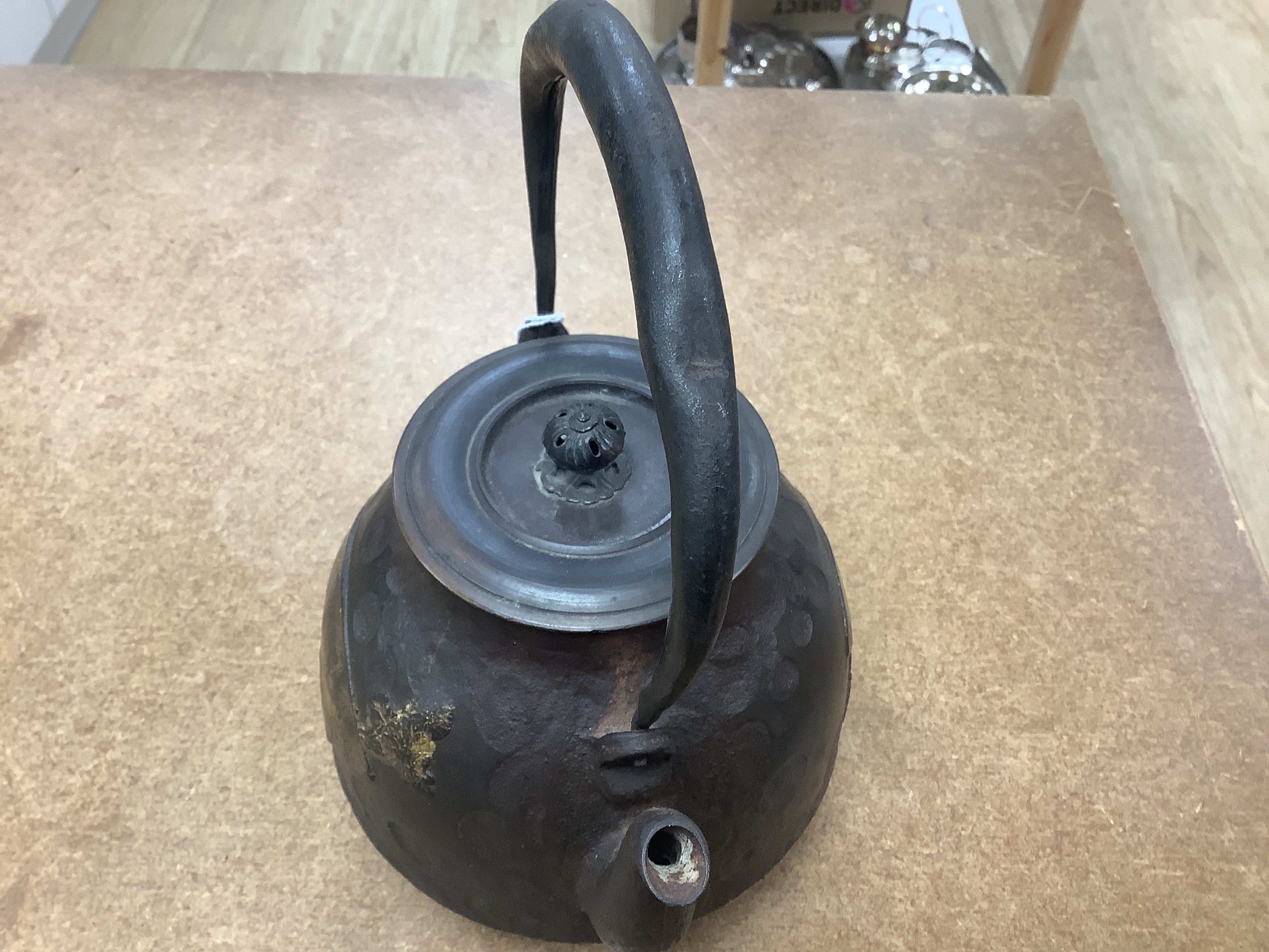 A Japanese iron tetsubin kettle with gilt decoration, a pair of Chinese cloisonné enamel vases, 12.5cm, a lacquered box with mother of pearl inlay, a carved black stone disc, 5cm diameter, a miniature ceramic pot and an
